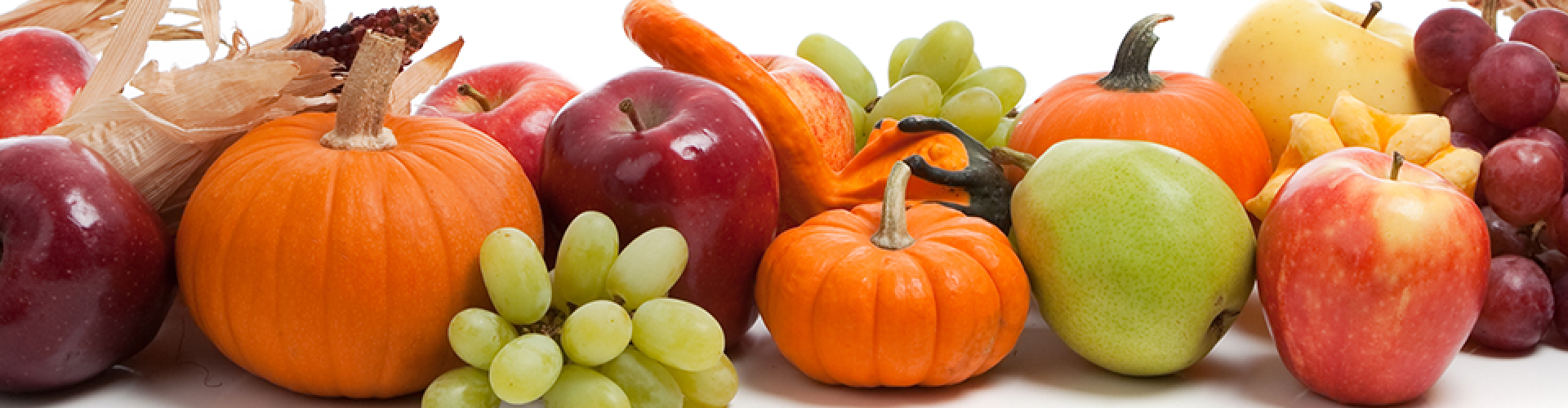 various fruits and vegetables including apples, grapes, ckorn and pumpkins