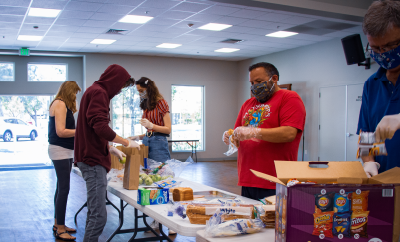 Generous Living; people packing lunches for people in need