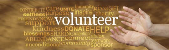 open hands over a background with various words connected to volunteering